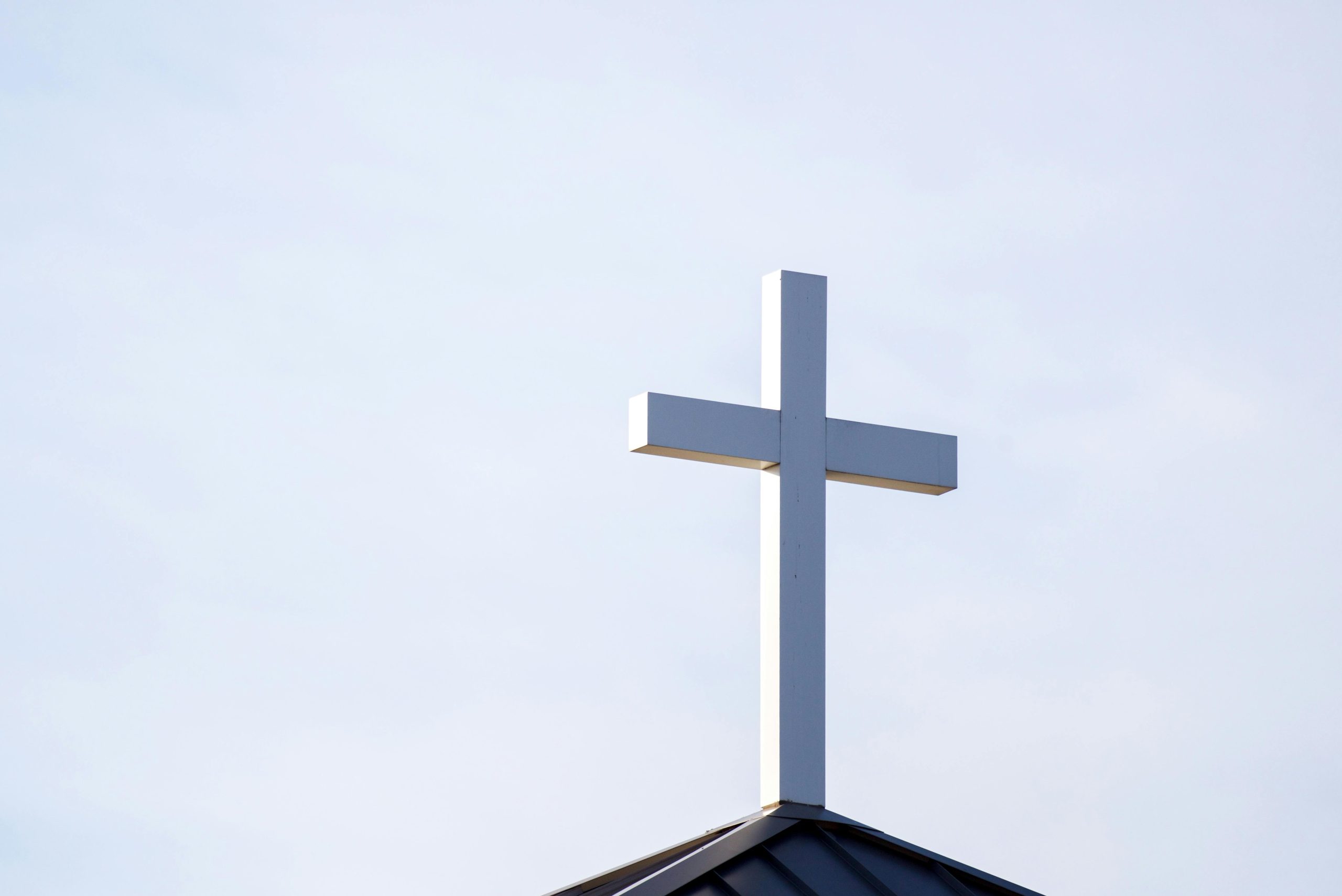 A cross on top of a church | Image Source: Pexels